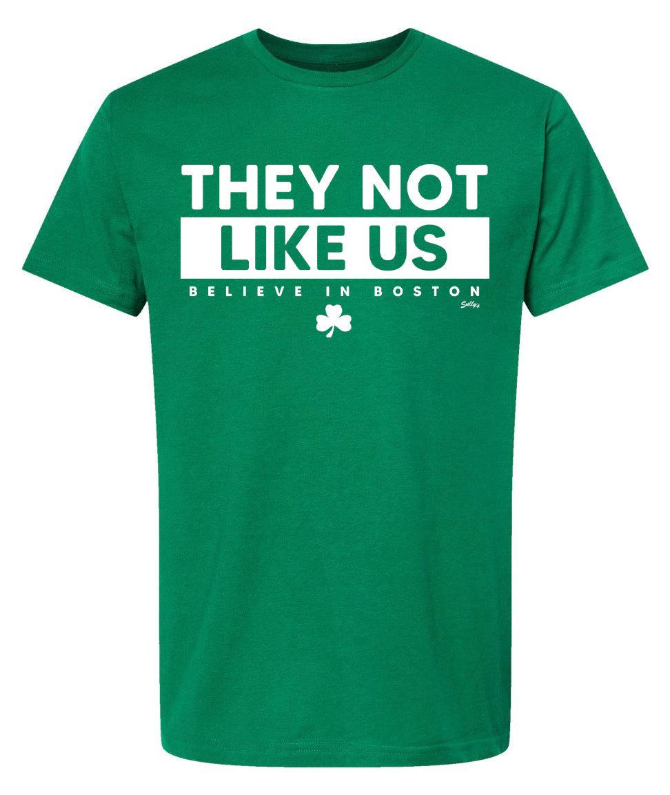 Green T-shirt that says "They Not Like US Believe in Boston" In white font.