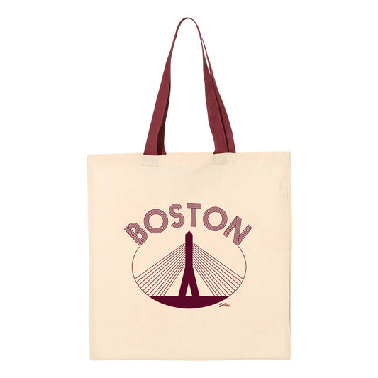 Beige colored tote bag with Boston and image of the Zakim bridge and handle in red. 
